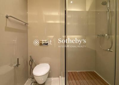 Modern bathroom with glass shower and wall-mounted toilet