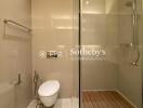 Modern bathroom with glass shower and wall-mounted toilet