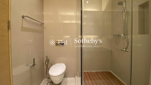 Modern bathroom with glass shower and wall-mounted toilet