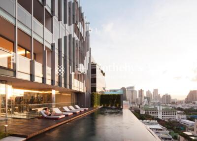 Modern high-rise building with rooftop pool and city view