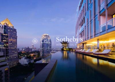 Modern high-rise building with an infinity pool and city skyline view