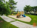 Children's play area with slide and tic-tac-toe board surrounded by greenery