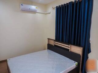 Spacious bedroom with air conditioning and dark curtains