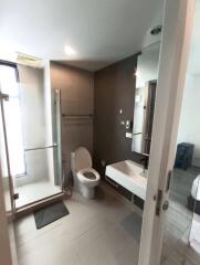 Modern bathroom featuring a shower, toilet, and sink