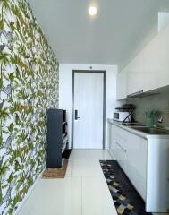 Modern kitchen with patterned wall and white cabinetry