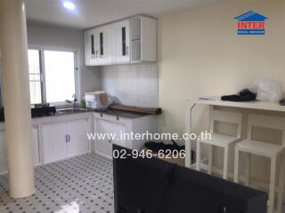 Modern kitchen with white cabinets and tiled floor