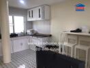 Modern kitchen with white cabinets and tiled floor