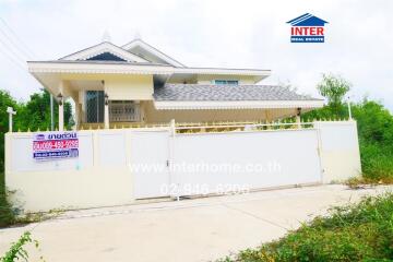 Front view of a house with a gated fence and landscaping