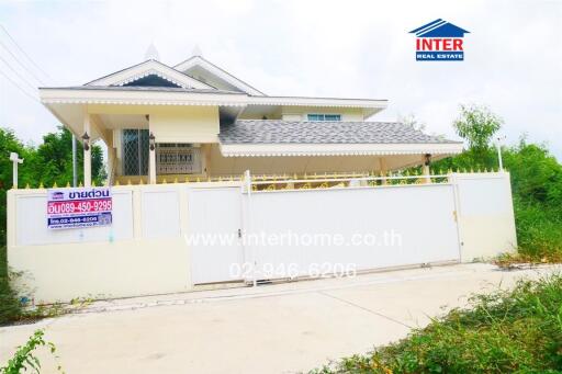 Front view of a house with a gated fence and landscaping