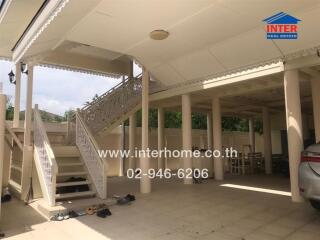 Covered outdoor area with stairs and parking space