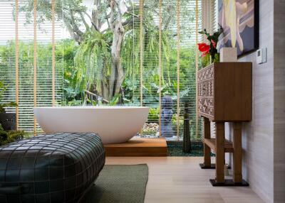 Modern bathroom with a freestanding tub and large window