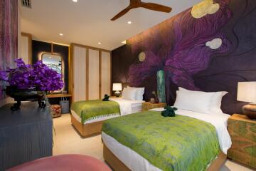 Bedroom with two beds, floral-themed wall art, and modern decor