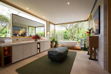 Luxurious bathroom with large mirror and a view of greenery