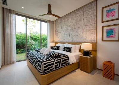 Modern bedroom with large bed and garden view