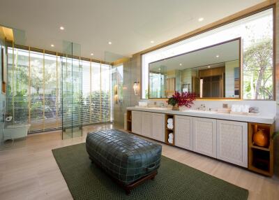 Luxurious modern bathroom with large vanity and spacious seating area