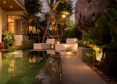 Outdoor seating area with pool and night lighting