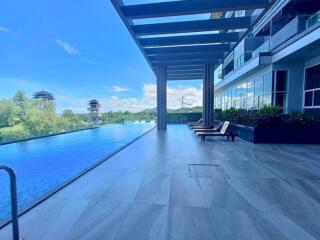 Rooftop infinity pool with lounge chairs