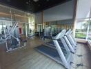 Modern gym with various fitness equipment including treadmills and weight machines