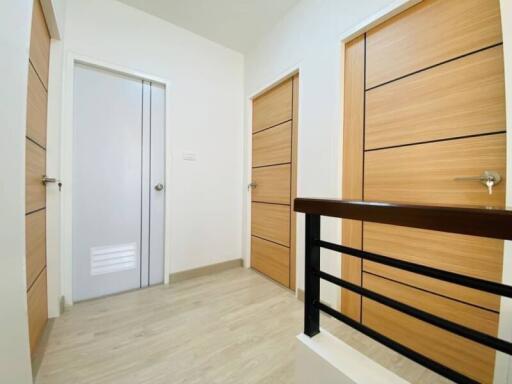 Modern hallway with multiple wooden doors