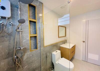 Modern bathroom with glass shower enclosure and mounted showerheads