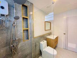 Modern bathroom with glass shower enclosure and mounted showerheads