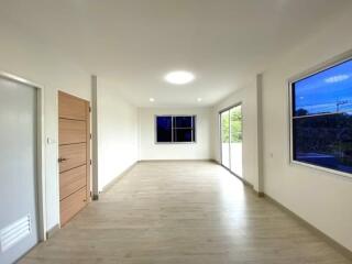 spacious well-lit living area with large windows