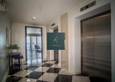 Elevator lobby area with two elevators and decorative floor