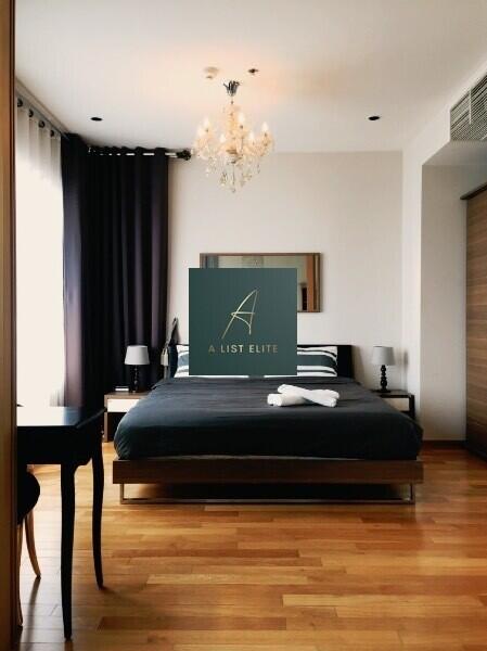 Modern bedroom with wooden flooring and large bed