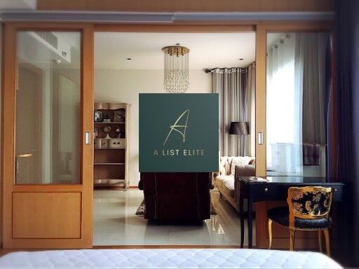 A stylish living room with a chandelier, wooden partition, and sliding doors