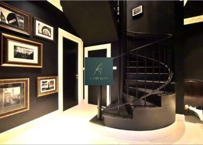 Modern interior space with spiral staircase and framed artwork