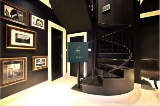 Modern interior space with spiral staircase and framed artwork