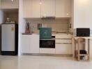 Modern kitchen with white cabinetry and appliances