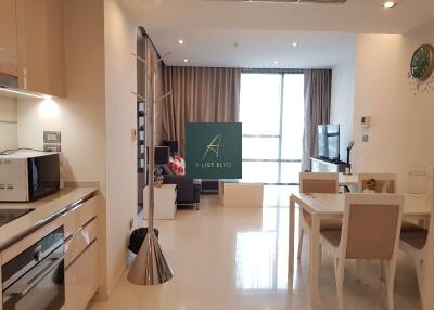 Open concept living room and kitchen with modern furniture and fixtures.