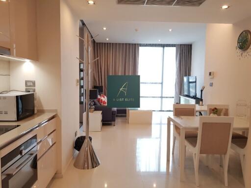 Open concept living room and kitchen with modern furniture and fixtures.