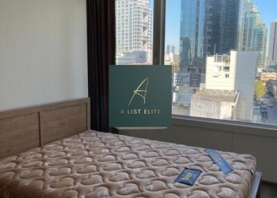 Bedroom with a large window and city view