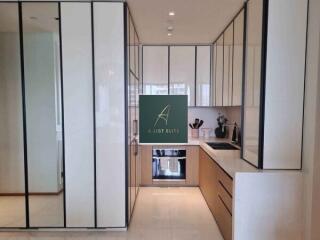 Modern kitchen with sleek white cabinetry and appliances