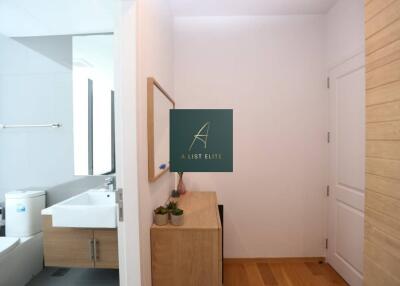 Modern bathroom with wooden cabinetry and white fixtures