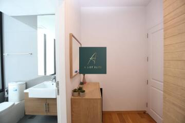 Modern bathroom with wooden cabinetry and white fixtures