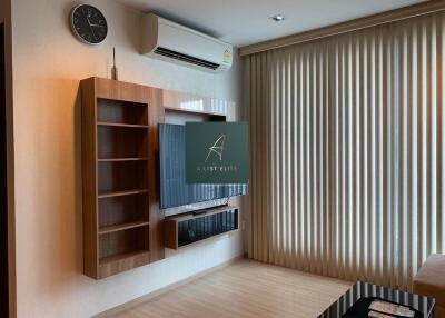 Modern living room with wall-mounted TV and air conditioning