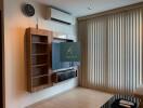 Modern living room with wall-mounted TV and air conditioning