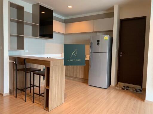 Modern kitchen with wood finish cabinets and island