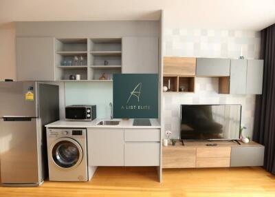 Modern kitchen with integrated appliances and media area