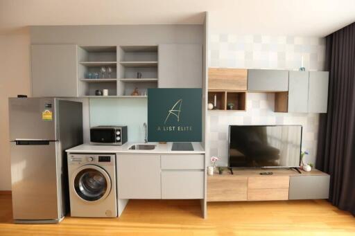 Modern kitchen with integrated appliances and media area