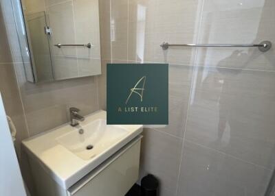 Modern bathroom with a sink, mirror cabinet, and tiled walls