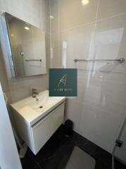 Modern bathroom with a sink, mirror cabinet, and tiled walls