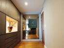 Hallway view with decorative elements and large mirror