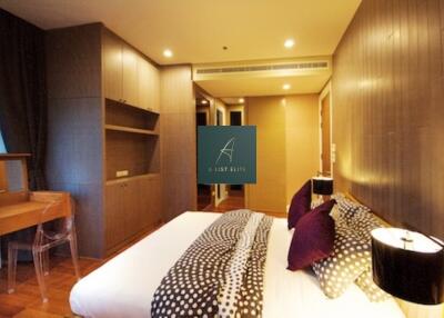 Modern bedroom with double bed, wooden furniture, and ambient lighting