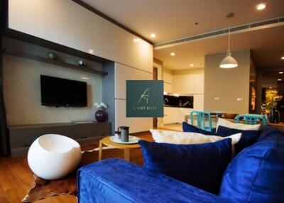 Modern living room with blue sofa and entertainment center