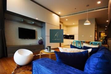 Modern living room with blue sofa and entertainment center