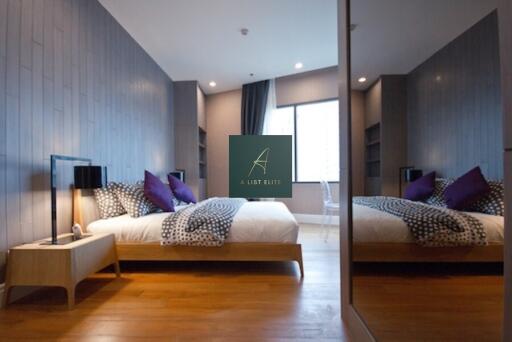 Modern bedroom with mirrored closet, king-size bed, and wooden flooring